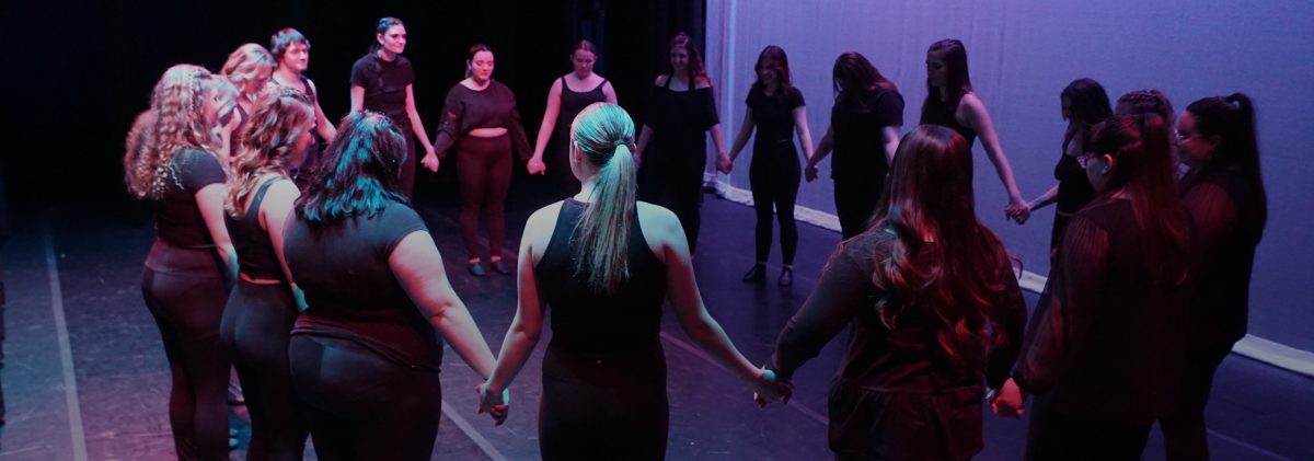 dance club members holding hands in a circle